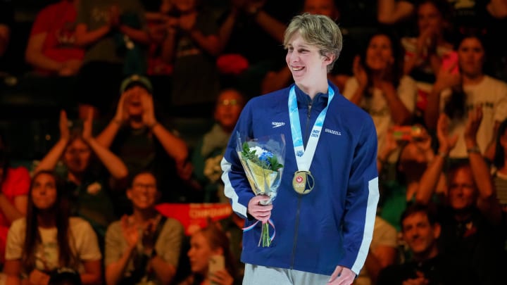 Aaron Shackell is cheered for by the crowd after receiving her medal for the 400 freestyle final Saturday, June 15, 2024, during the first day of competition for the U.S. Olympic Team Swimming Trials at Lucas Oil Stadium in Indianapolis.