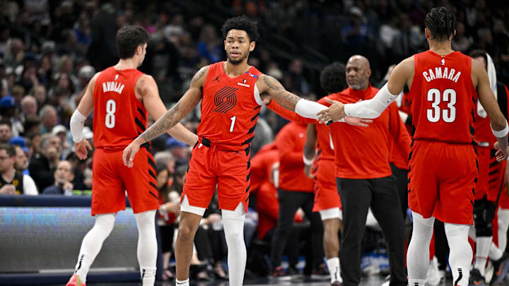 Dec 23, 2024; Dallas, Texas, USA; Portland Trail Blazers forward Deni Avdija (8) and guard Anfernee Simons (1) and forward Toumani Camara (33) walk back to the bench during the second quarter against the Dallas Mavericks at the American Airlines Center. Mandatory Credit: Jerome Miron-Imagn Images Dec 23, 2024; Dallas, Texas, USA; Portland Trail Blazers forward Deni Avdija (8) and guard Anfernee Simons (1) and forward Toumani Camara (33) walk back to the bench during the second quarter against the Dallas Mavericks at the American Airlines Center. Mandatory Credit: Jerome Miron-Imagn Images