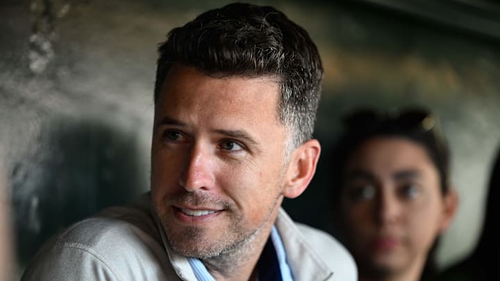 Jun 4, 2025; San Francisco, California, USA; Former San Francisco Giants player Buster Posey sits in the dugout before the game against the San Diego Padres at Oracle Park.