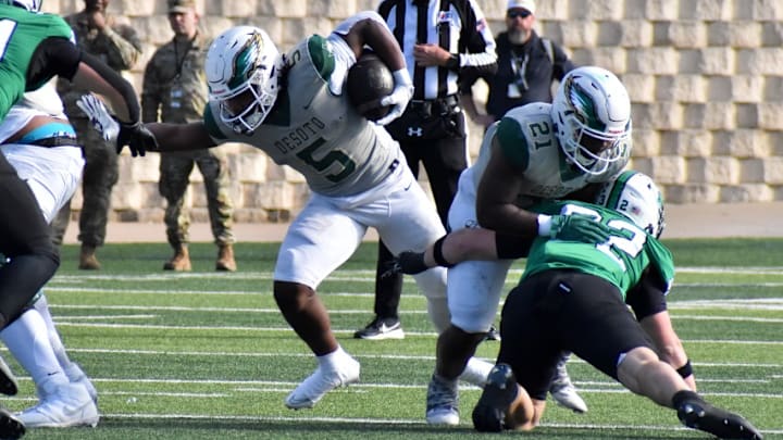 DeSoto's SaRod Baker (5) runs the ball during the first quarter of a playoff game on Saturday against Southlake Carroll.