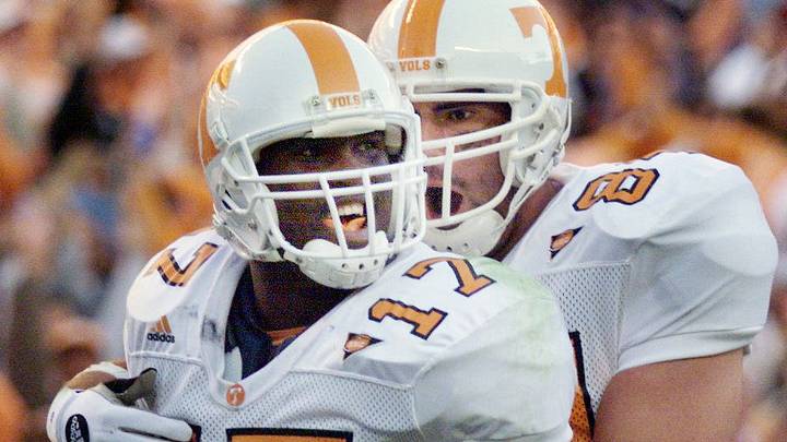 Tennessee quarterback Tee Martin (17) gets a hug from teammate Neil Johnson after he scored the Vols final touchdown against Alabama. Martin and teammates were the one smoking cigars after a 21-7 victory over Alabama before 86,869 at Bryant-Denny Stadium in Tuscaloosa, Ala., on Oct. 23, 1999. Tennessee quarterback Tee Martin (17) gets a hug from teammate Neil Johnson after he scored the Vols final touchdown against Alabama. Martin and teammates were the one smoking cigars after a 21-7 victory over Alabama before 86,869 at Bryant-Denny Stadium in Tuscaloosa, Ala., on Oct. 23, 1999.