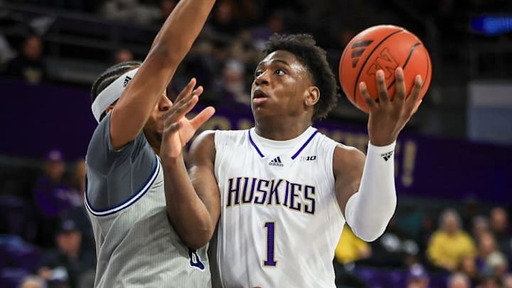UW power forward Great Osobor tries to get to the hoop in the opener against UC Davis.