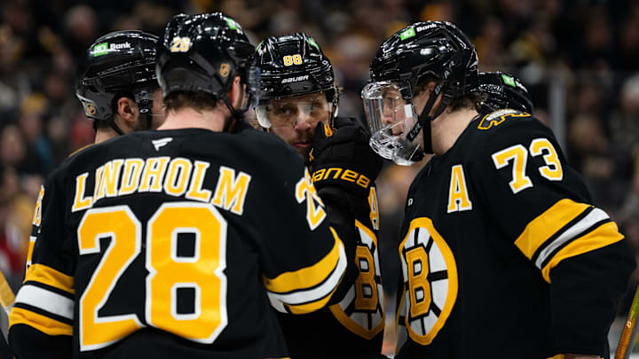 Jan 13, 2026; Boston, Massachusetts, USA; Boston Bruins center Elias Lindholm (28), right-winger David Pastrnak (88), and defenseman Charlie McAvoy (73) talk during a stop in play during the second period of the game against the Detroit Red Wings at TD Garden. Mandatory Credit: Natalie Reid-Imagn Images