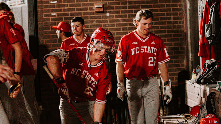 2B Luke Nixon (middle) participates in NC State's hockey celebration after hitting a home run in his team's 10-3 road win over East Carolina on Tuesday, April 15, 2026 in Greenville, N.C. 