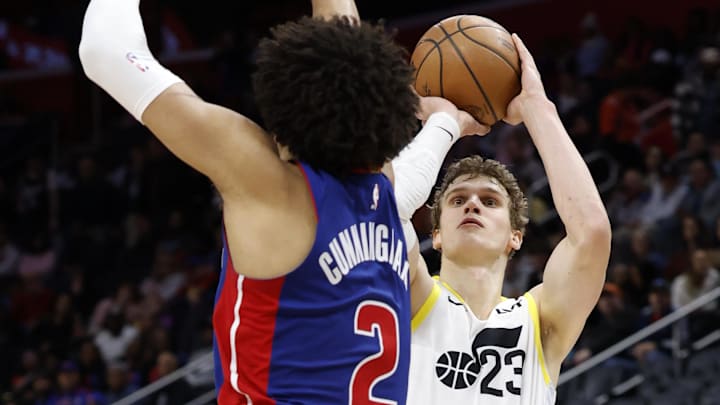 Dec 19, 2024; Detroit, Michigan, USA;  Utah Jazz forward Lauri Markkanen (23) shoots on Detroit Pistons guard Cade Cunningham (2) in the third quarter at Little Caesars Arena. 