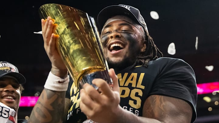Jan 20, 2025; Atlanta, GA, USA; Ohio State Buckeyes defensive tackle Tyleik Williams (91) celebrates with the trophy after defeating the Notre Dame Fighting Irish during the CFP National Championship college football game at Mercedes-Benz Stadium. Mandatory Credit: Mark J. Rebilas-Imagn Images Jan 20, 2025; Atlanta, GA, USA; Ohio State Buckeyes defensive tackle Tyleik Williams (91) celebrates with the trophy after defeating the Notre Dame Fighting Irish during the CFP National Championship college football game at Mercedes-Benz Stadium. Mandatory Credit: Mark J. Rebilas-Imagn Images