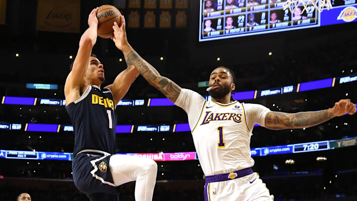 Apr 27, 2024; Los Angeles, California, USA; Denver Nuggets forward Michael Porter Jr. (1) drives against Los Angeles Lakers guard D'Angelo Russell (1) during the third quarter in game four of the first round for the 2024 NBA playoffs at Crypto.com Arena. Mandatory Credit: Jason Parkhurst-USA TODAY Sports