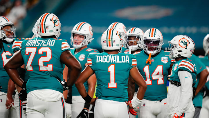 Miami Dolphins offensive tackle Terron Armstead (72) and Miami Dolphins quarterback Tua Tagovailoa (1) talk to teammates prior to a game against the Pittsburgh Steelers at Hard Rock Stadium in 2022.