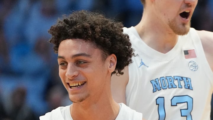 Feb 2, 2026; Chapel Hill, North Carolina, USA; North Carolina Tar Heels guard Kyan Evans (0) and center Henri Veesaar (13) and forward Jonathan Powell (11) react in the first half at Dean E. Smith Center. Mandatory Credit: Bob Donnan-Imagn Images