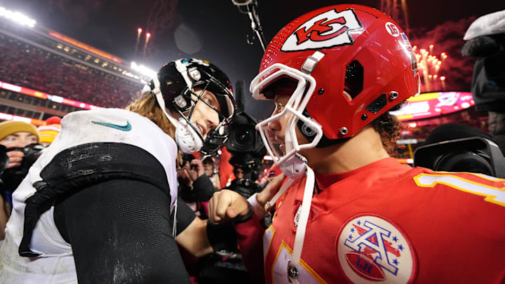 Jan 21, 2023; Kansas City, Missouri, USA; Kansas City Chiefs quarterback Patrick Mahomes (15) meets with Jacksonville Jaguars quarterback Trevor Lawrence (16) following the AFC divisional round game at GEHA Field at Arrowhead Stadium. Mandatory Credit: Jay Biggerstaff-Imagn Images