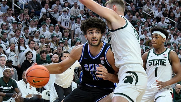Dec 6, 2025; East Lansing, Michigan, USA; Duke Blue Devils forward Cameron Boozer (12) advances against Michigan State Spartans center Carson Cooper (15) during the first half at Jack Breslin Student Events Center. Mandatory Credit: Dale Young-Imagn Images Dec 6, 2025; East Lansing, Michigan, USA; Duke Blue Devils forward Cameron Boozer (12) advances against Michigan State Spartans center Carson Cooper (15) during the first half at Jack Breslin Student Events Center. Mandatory Credit: Dale Young-Imagn Images
