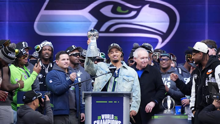 Jaxon Smith-Njigba holds up the Vince Lombardi trophy during the Super Bowl LX celebration.