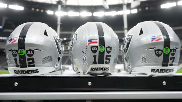 Nov 23, 2025; Paradise, Nevada, USA; The Las Vegas Raiders helmets of Las Vegas Raiders quarterback Aidan O'Connell (12), quarterback Kenny Pickett (15) and quarterback Geno Smith (7) with the Salute to Service decals and emblems honoring Al Davis and Carol Davis at Allegiant Stadium. Mandatory Credit: Kirby Lee-Imagn Images Nov 23, 2025; Paradise, Nevada, USA; The Las Vegas Raiders helmets of Las Vegas Raiders quarterback Aidan O'Connell (12), quarterback Kenny Pickett (15) and quarterback Geno Smith (7) with the Salute to Service decals and emblems honoring Al Davis and Carol Davis at Allegiant Stadium. Mandatory Credit: Kirby Lee-Imagn Images
