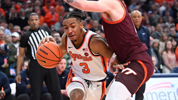 Feb 27, 2024; Syracuse, New York, USA; Syracuse Orange guard Judah Mintz (3) tries to move the ball past Virginia Tech Hokies guard Hunter Cattoor in the second half at the JMA Wireless Dome. Mandatory Credit: Mark Konezny-Imagn Images