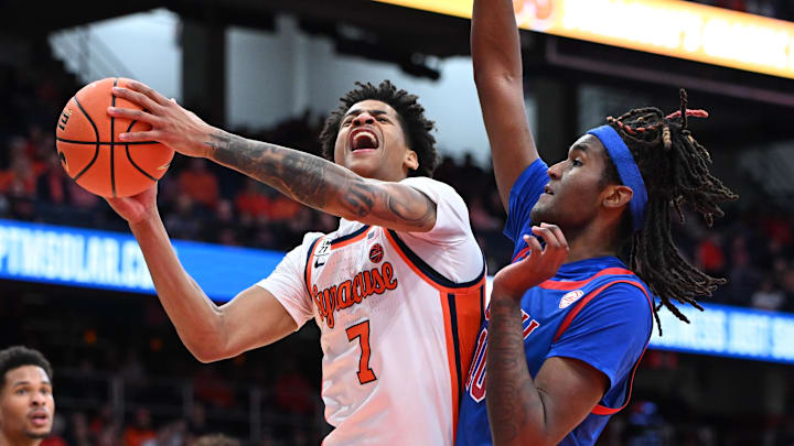 Feb 14, 2026; Syracuse, New York, USA; Syracuse Orange forward Kiyan Anthony (7) is fouled by Southern Methodist University Mustangs center Jaden Toombs (10) during a shot in the second half at the JMA Wireless Dome. Mandatory Credit: Mark Konezny-Imagn Images