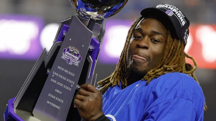 Jeanty hoists the Mountain West Trophy after Boise State beat UNLV 21-7 in the conference championship.