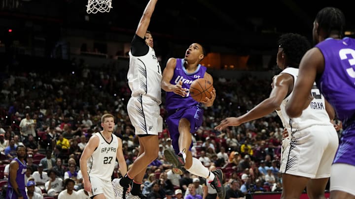 Jul 14, 2025; Las Vegas, NV, USA;  Utah Jazz forward John Tonje (17) drives towards the basket against San Antonio Spurs forward Carter Bryant (11) during the first half of a NBA basketball game at the Thomas & Mack Center. Mandatory Credit: Lucas Peltier-Imagn Images