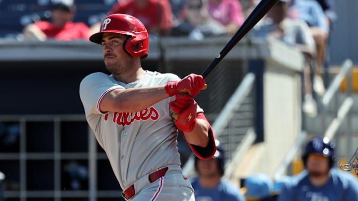 Feb 25, 2025; Port Charlotte, Florida, USA;  Philadelphia Phillies infielder Otto Kemp (82) hits a RBI double against the Tampa Bay Rays during the fourth inning at Charlotte Sports Park.
