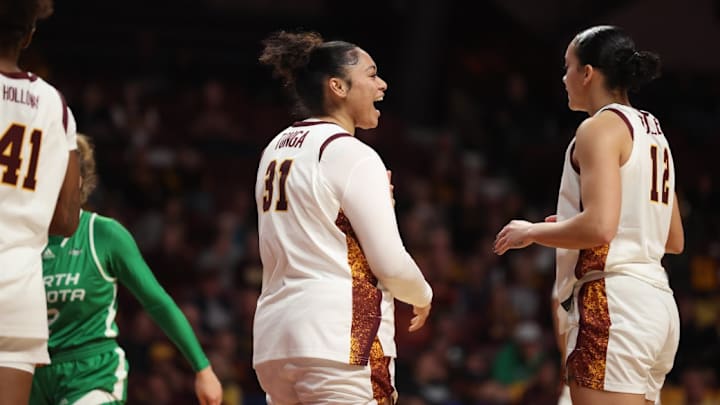 Gophers veteran forward Finau Tonga (No. 31) celebrating with guard Brylee Gleen (No. 12) in their season opening win against North Dakota.