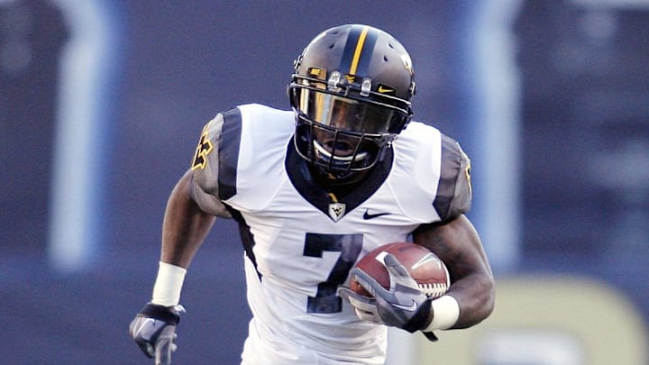 Nov 26, 2010; Pittsburgh, PA, USA; West Virginia Mountaineers running back Noel Devine (7) runs in the open field against the Pittsburgh Panthers during the fourth quarter at Heinz Field. West Virginia won 35-10. Mandatory Credit: Charles LeClaire-USPRESSWIRE