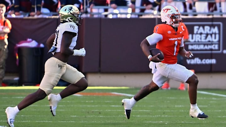 Oct 4, 2025; Blacksburg, Va.; Virginia Tech quarterback Kyron Drones (1) runs toward the sideline with the ball against Wake Forest linebacker Aiden Hall (21).