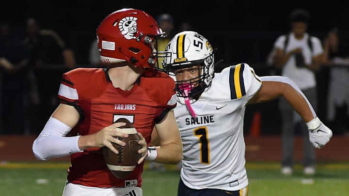 Quarterback Collin Steele of Monroe is sacked by Isaiah Harris of Saline Friday, Sept. 20, 2024.