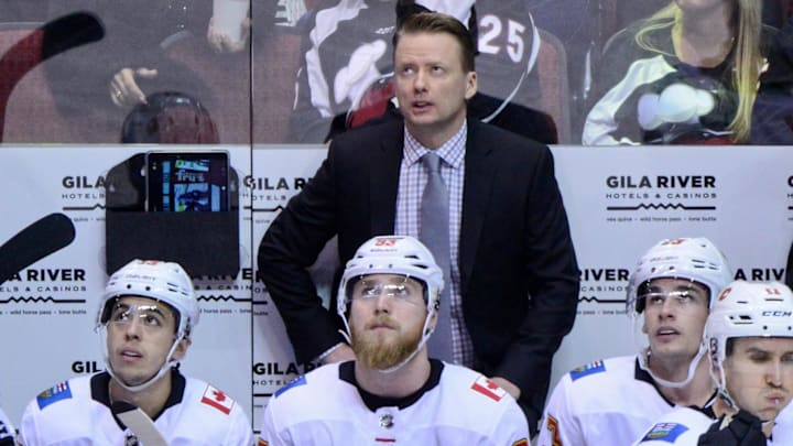 Mar 19, 2018; Glendale, AZ, USA; Calgary Flames head coach Glen Gulutzan looks on during the first period against the Arizona Coyotes at Gila River Arena. Mandatory Credit: Matt Kartozian-Imagn Images