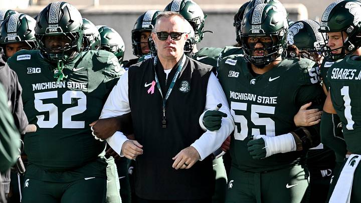 Michigan State’s head coach Pat Fitzgerald, center, is flanked by Nick Sharpe, left, and Ben Roberts as the team walks the end zone before the football game against Northwestern on Saturday, Oct. 17, 2026, at Spartan Stadium in East Lansing.