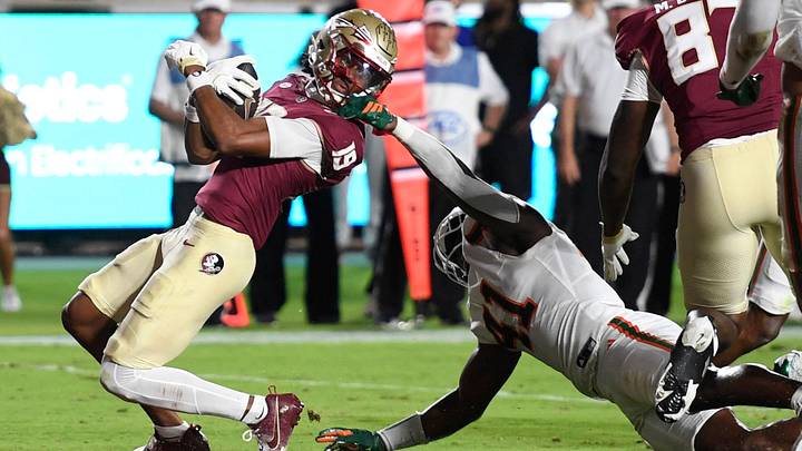 Oct 4, 2025; Tallahassee, Florida, USA; Florida State Seminoles wide receiver Micahi Danzy (19) is face masked by Miami Hurricanes linebacker Chase Smith (41) during the second half at Doak S. Campbell Stadium. Mandatory Credit: Robert Myers-Imagn Images Oct 4, 2025; Tallahassee, Florida, USA; Florida State Seminoles wide receiver Micahi Danzy (19) is face masked by Miami Hurricanes linebacker Chase Smith (41) during the second half at Doak S. Campbell Stadium. Mandatory Credit: Robert Myers-Imagn Images