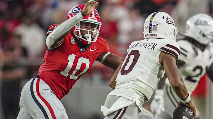 Oct 12, 2024; Athens, Georgia, USA; Georgia Bulldogs linebacker Damon Wilson II (10) tries to tackle Mississippi State Bulldogs quarterback Michael Van Buren Jr. (0) at Sanford Stadium. Mandatory Credit: Dale Zanine-Imagn Images