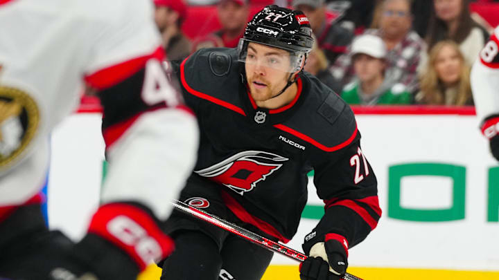 Dec 13, 2024; Raleigh, North Carolina, USA; Carolina Hurricanes center Tyson Jost (27) skates against the Ottawa Senators during the first period at Lenovo Center. Mandatory Credit: James Guillory-Imagn Images
