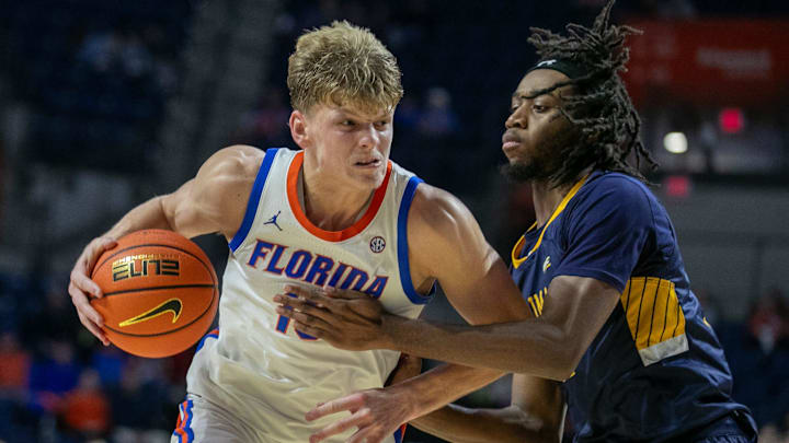 Florida Gators forward Thomas Haugh (10) drives against Merrimack College Jordan McKoy (24) for the shot during second half action of an NCAA basketball game as Florida Gators take on Merrimack College Warrors at Exactech Areana in Gainesville, FL on Tuesday, December 5, 2023. [Alan Youngblood/Gainesville Sun]