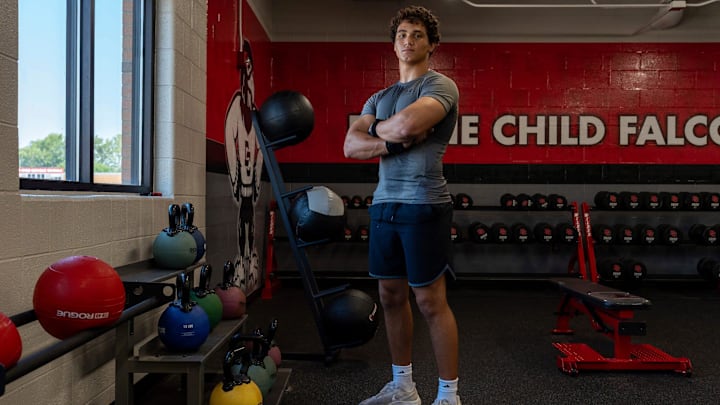 Marcello Vitti, 18, a senior at Divine Child High School and one of the top football recruits in Michigan, stands next to a kettlebell rack during a morning practice in Dearborn on Thursday, July 24, 2025.