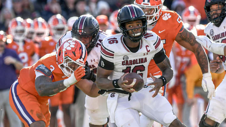 Nov 30, 2024; Clemson, South Carolina, USA; South Carolina quarterback LaNorris Sellers (16) runs away from Clemson defensive end T.J. Parker (3) during the fourth quarter at Memorial Stadium. Mandatory Credit: Ken Ruinard-Imagn Images