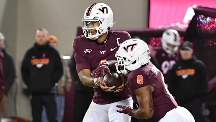 Oct 24, 2025; Blacksburg, Virginia, USA;  Virginia Tech Hokies quarterback Kyron Drones (1) hands the ball off to running back Terion Stewart (8) against the California Golden Bears during the first quarter at Lane Stadium. Mandatory Credit: Brian Bishop-Imagn Images