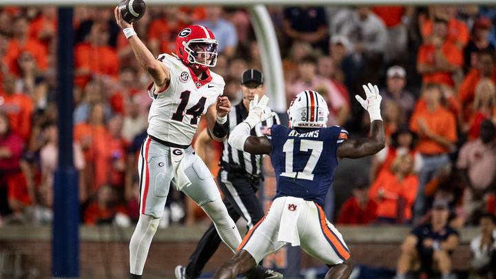 Georgia Bulldogs quarterback Gunner Stockton (14) throws the ball with pressure from Auburn Tigers linebacker Xavier Atkins (17) as Auburn Tigers take on Georgia Bulldogs at Jordan-Hare Stadium in Auburn, Ala. on Saturday, Oct. 11, 2025.