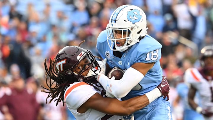 Oct 1, 2022; Chapel Hill, North Carolina, USA; North Carolina Tar Heels tight end Bryson Nesbit (18) makes a catch as Virginia Tech Hokies defensive back Jalen Stroman (26) defends in the third quarter at Kenan Memorial Stadium. Mandatory Credit: Bob Donnan-Imagn Images
