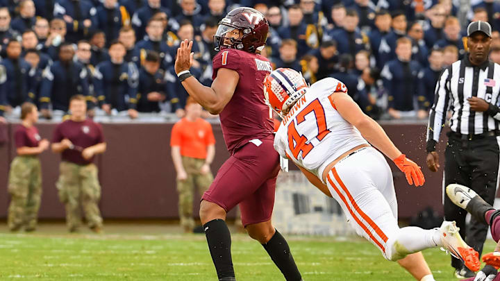 Nov 9, 2024; Blacksburg, Virginia, USA; Virginia Tech Hokies quarterback Kyron Drones (1) throws a pass while being pressured by Clemson Tigers linebacker Sammy Brown (47) during the second quarter at Lane Stadium. Mandatory Credit: Brian Bishop-Imagn Images