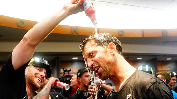 Arizona Diamondbacks starting pitcher Merrill Kelly pours beer over general manager Mike Hazen during celebrations after clinching a wild-card playoff spot following their game with the Houston Astros at Chase Field in Phoenix on Sept. 30, 2023. Arizona Diamondbacks starting pitcher Merrill Kelly pours beer over general manager Mike Hazen during celebrations after clinching a wild-card playoff spot following their game with the Houston Astros at Chase Field in Phoenix on Sept. 30, 2023.