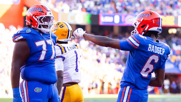 Florida Gators wide receiver Elijhah Badger (6) celebrates with teammate Florida Gators offensive lineman Knijeah Harris (77) after hauling in a pass over LSU Tigers cornerback Ashton Stamps (1) to score a touchdown during the first half at Ben Hill Griffin Stadium in Gainesville, FL on Saturday, November 16, 2024. [Doug Engle/Gainesville Sun]