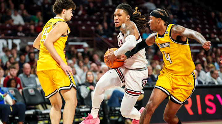 Nov 12, 2024; Columbia, South Carolina, USA; South Carolina Gamecocks guard Jamarii Thomas (6) drives past Towson Tigers guard Dylan Williamson (4) and guard Tyler Tejada (15) at Colonial Life Arena. Mandatory Credit: Jeff Blake-Imagn Images