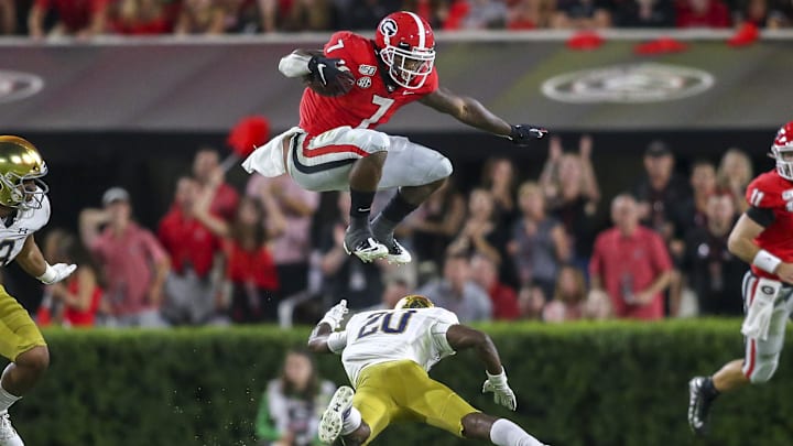 Sep 21, 2019; Athens, GA, USA; Georgia Bulldogs running back D'Andre Swift (7) hurdles Notre Dame Fighting Irish cornerback Shaun Crawford (20) in the third quarter at Sanford Stadium. Mandatory Credit: Brett Davis-Imagn Images
