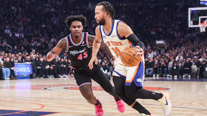 Dec 21, 2025; New York, New York, USA;  New York Knicks guard Jalen Brunson (11) drives past  Miami Heat guard Davion Mitchell (45) in the first quarter at Madison Square Garden.