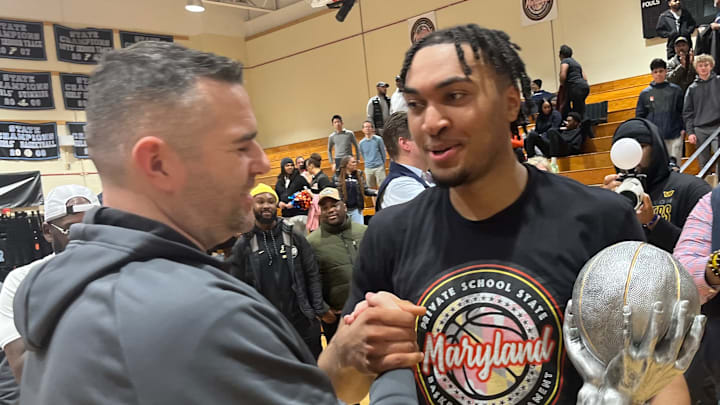 Bullis senior Adrien Stevens receives the Most Outstanding Player Trophy on Friday evening. The Marquette signee totaled 31 points, 12 rebounds and 12 assists in leading the Bulldogs to the Maryland Private Schools State Basketball Tournament crown.