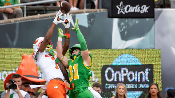 Oregon defensive back Dillon Thieneman, right, breaks up a pass intended for Oklahoma State wide receiver Shamar Rigby as the Oregon Ducks host the Oklahoma State Cowboys on Sept. 6, 2025, at Autzen Stadium in Eugene, Oregon.