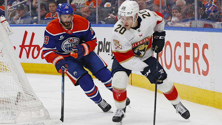 Mar 19, 2026; Edmonton, Alberta, CAN; Florida Panthers defensemen Mike Benning (20) looks to make a pass in front of Edmonton Oilers forward Adam Henrique (19) during the first period at Rogers Place. Mandatory Credit: Perry Nelson-Imagn Images Mar 19, 2026; Edmonton, Alberta, CAN; Florida Panthers defensemen Mike Benning (20) looks to make a pass in front of Edmonton Oilers forward Adam Henrique (19) during the first period at Rogers Place. Mandatory Credit: Perry Nelson-Imagn Images