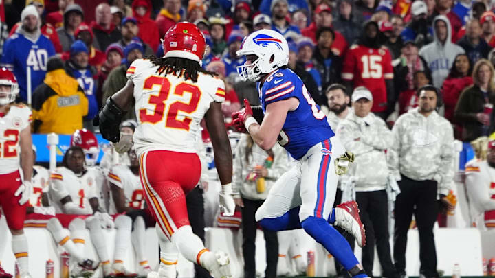 Nov 17, 2024; Orchard Park, New York, USA; Buffalo Bills tight end Dawson Knox (88) runs with the ball against Kansas City Chiefs linebacker Nick Bolton (32) during the second half at Highmark Stadium. Mandatory Credit: Gregory Fisher-Imagn Images