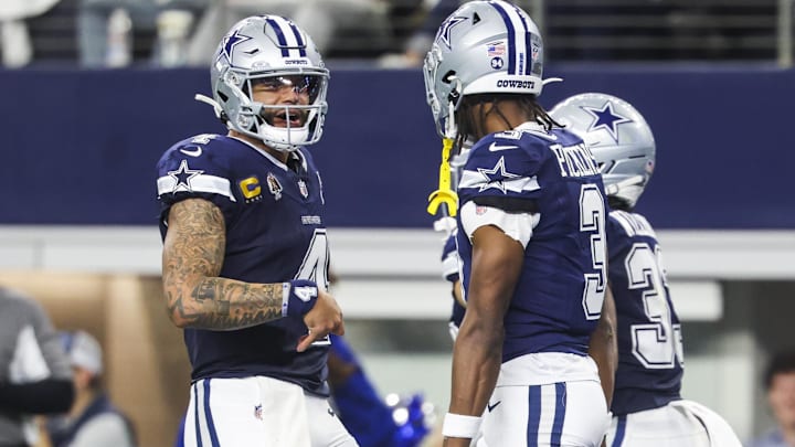 Dallas Cowboys quarterback Dak Prescott celebrates with wide receiver George Pickens after a touchdown pass.