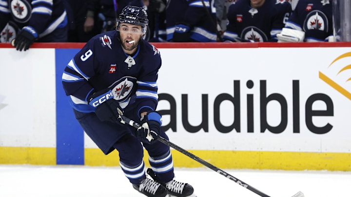 Apr 7, 2025; Winnipeg, Manitoba, CAN; Winnipeg Jets left wing Alex Iafallo (9) skates with the puck against the St. Louis Blues in the first period at Canada Life Centre. Mandatory Credit: James Carey Lauder-Imagn Images
