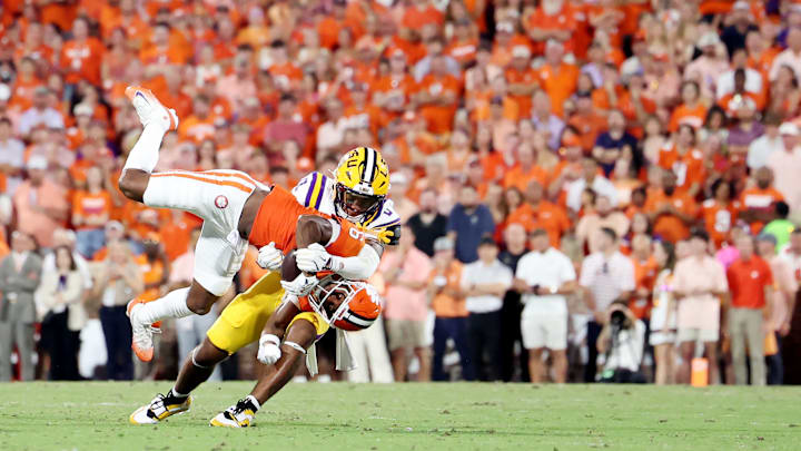 Clemson Wide Receiver Tyler Brown gets brought down hard by LSU defender Zavion Thomas in LSU v Clemson game